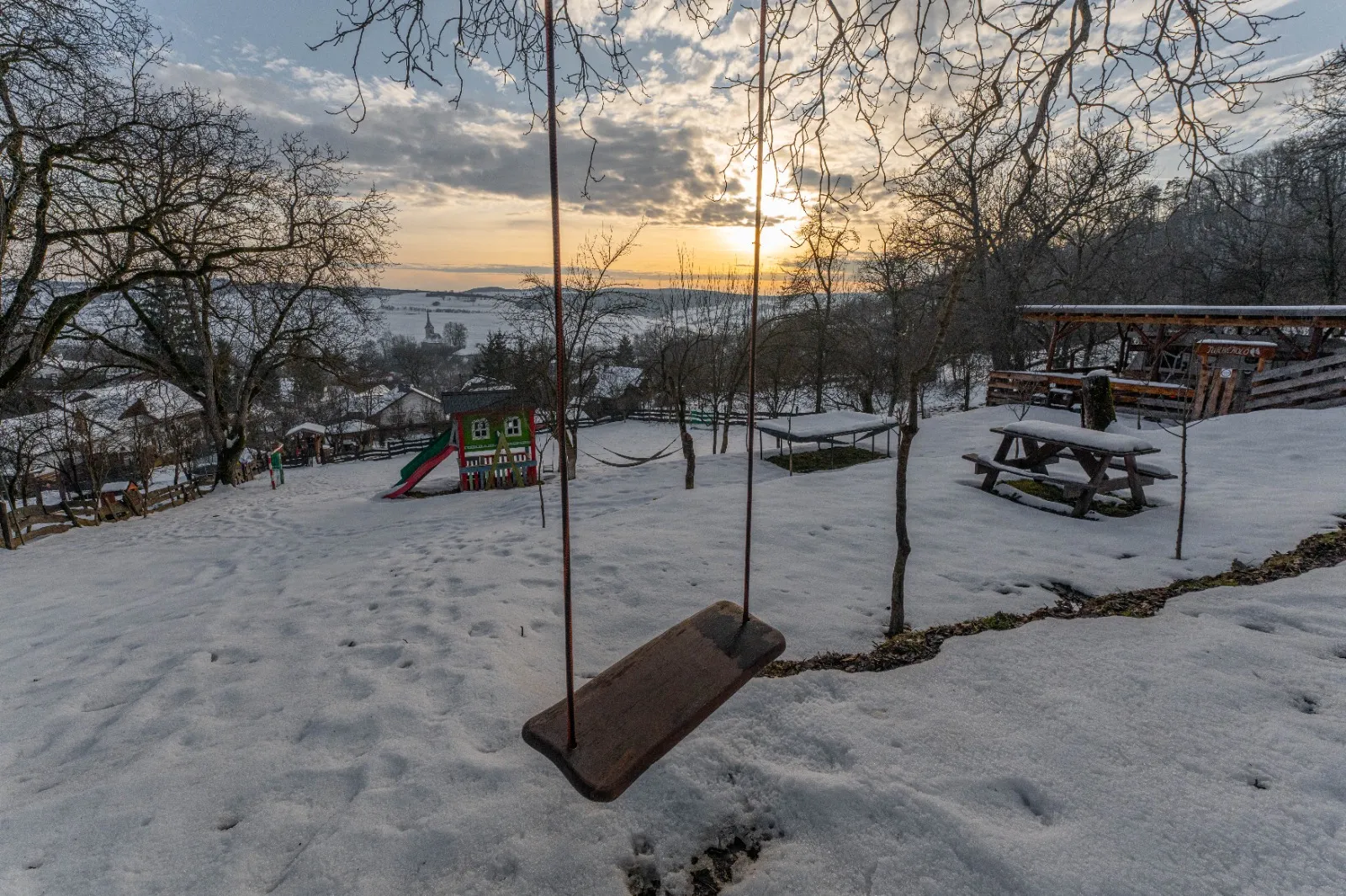 Winter sunset with a swing
