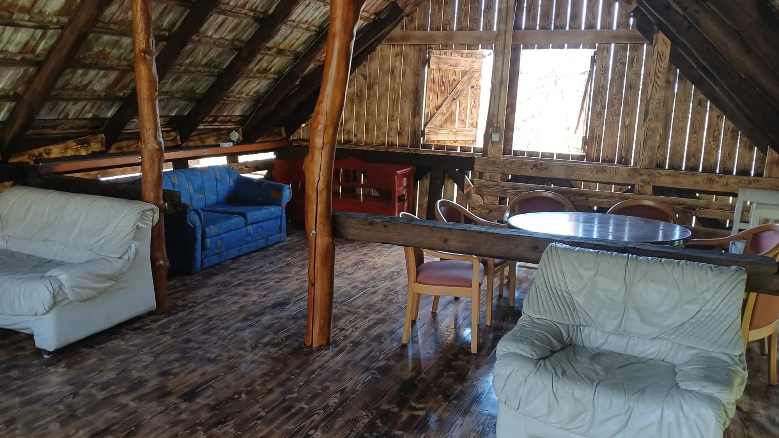 Barn loft lounge with sofas and a dining table