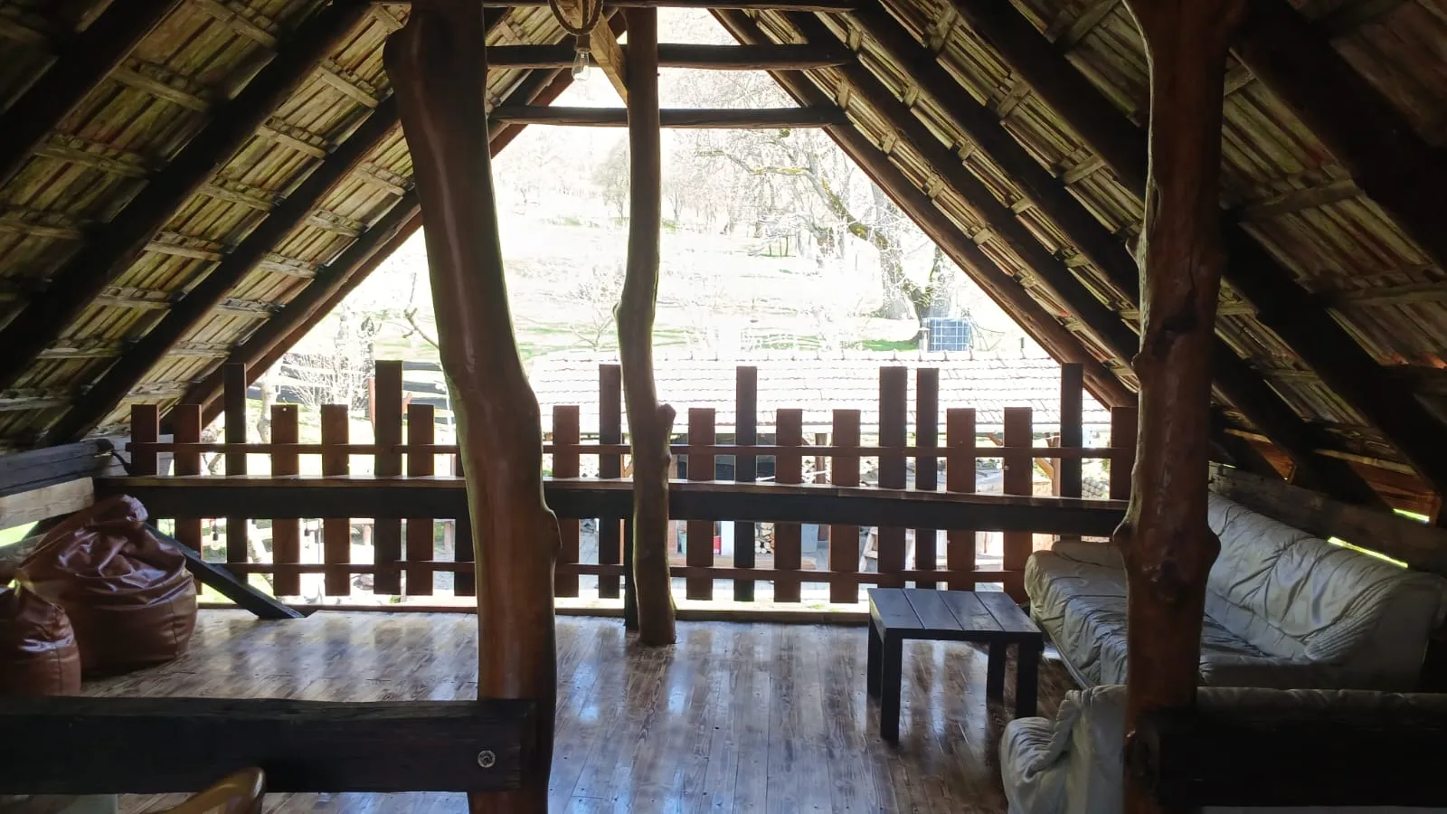 Open-air barn balcony with a seating area