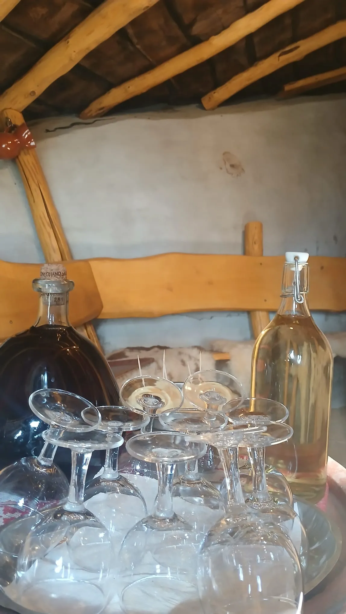 Wine bottles and glasses in the rustic cellar