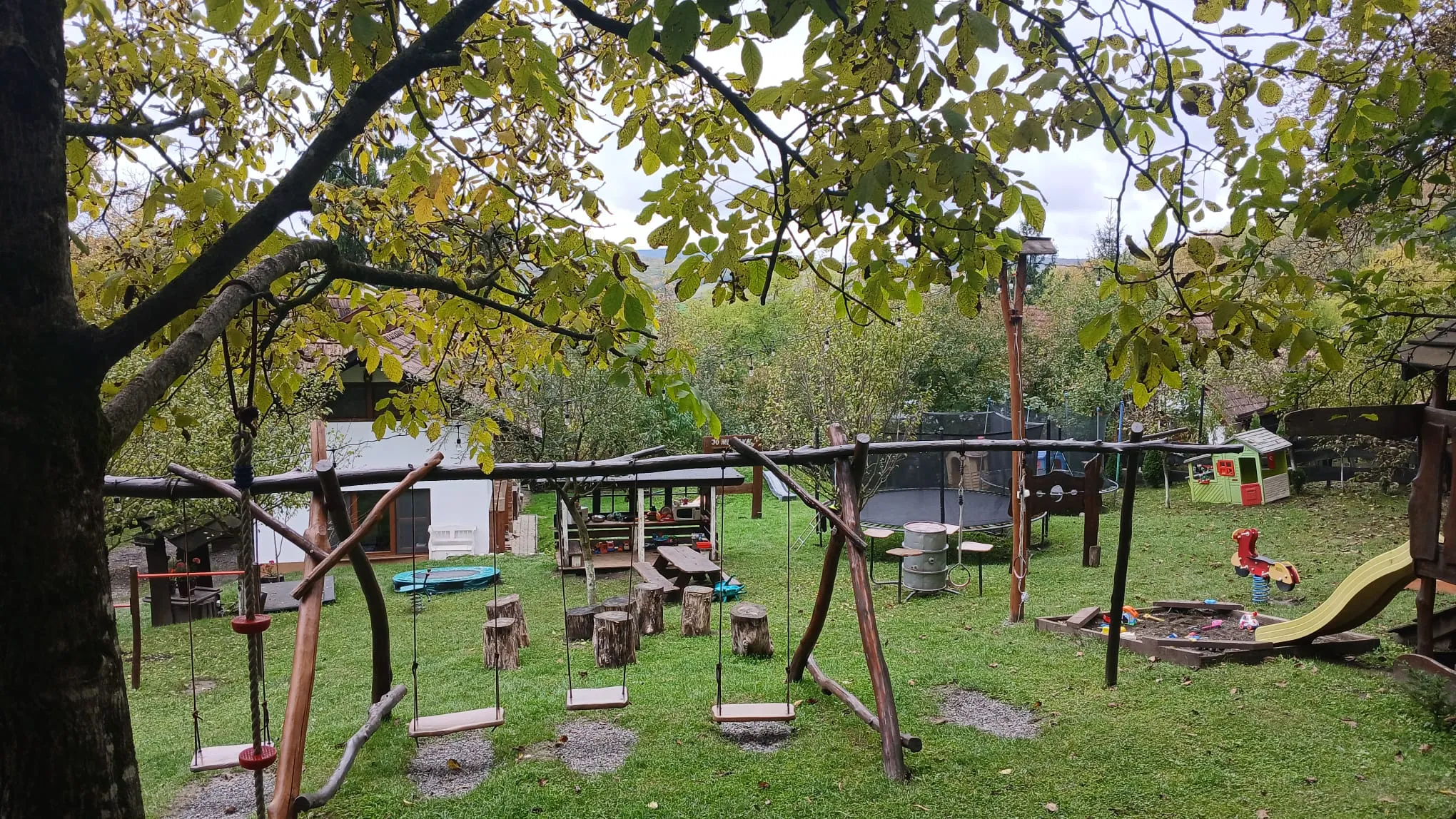 Autumn garden with swings and play equipment