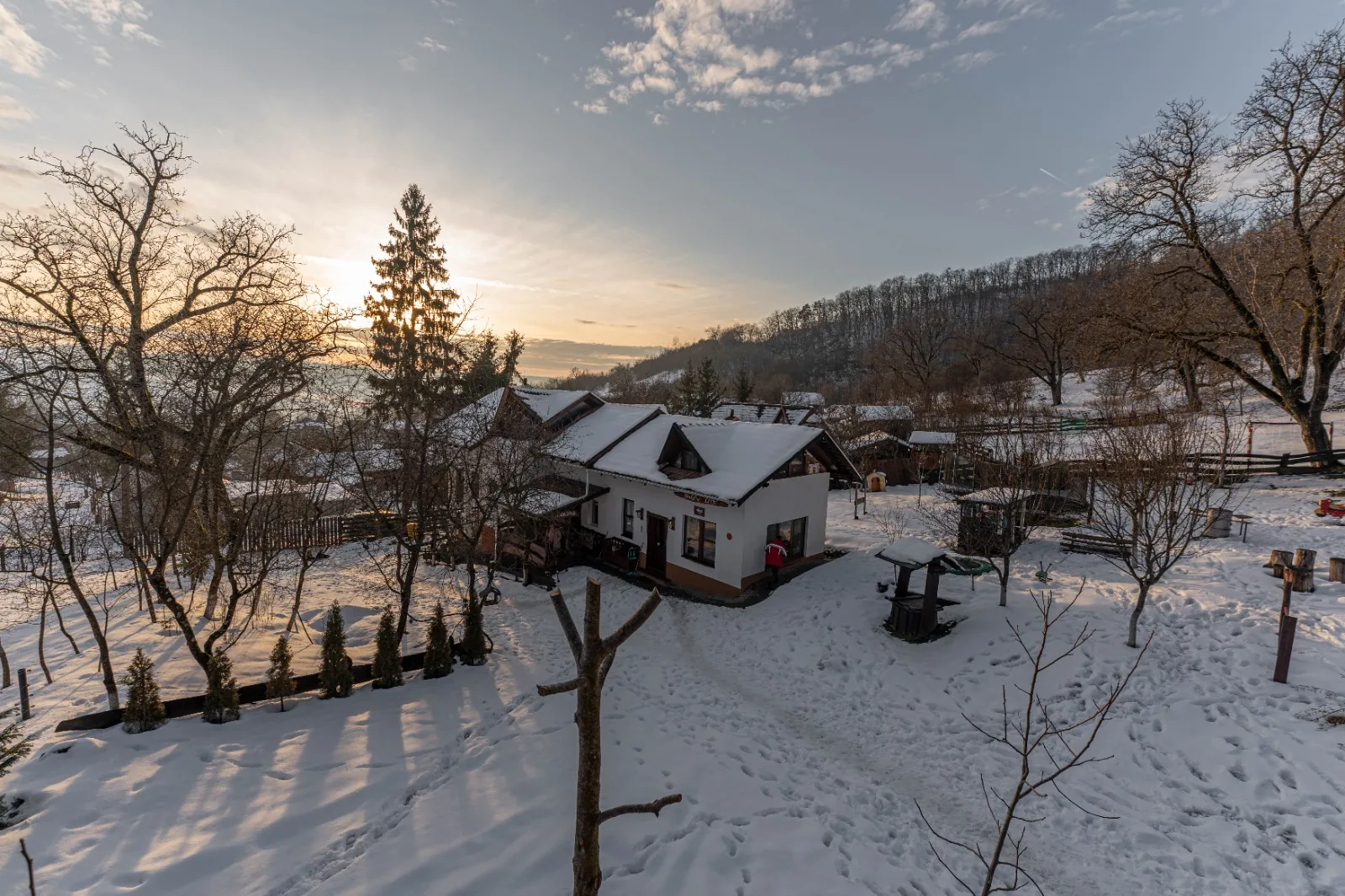 Aerial view of the Hagyó Lak guesthouse surrounded by forest in Transylvania