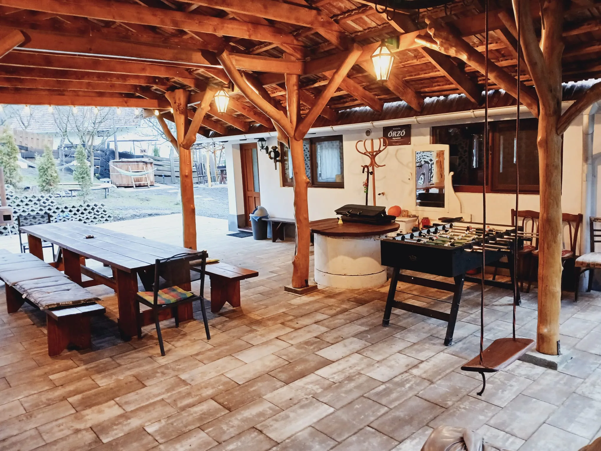 Covered terrace with a long table and table football